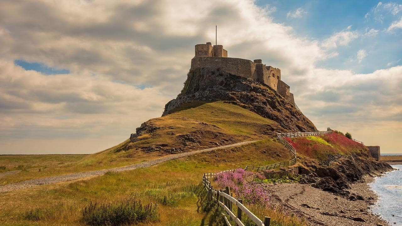 Panoramic view of Holy Island, showcasing the ancient ruins of Lindisfarne Priory.